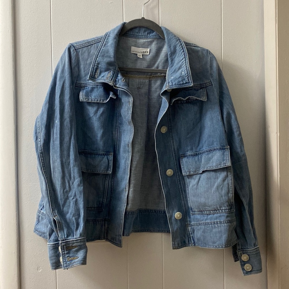 Light wash jean jacket button up through neck and cuffs